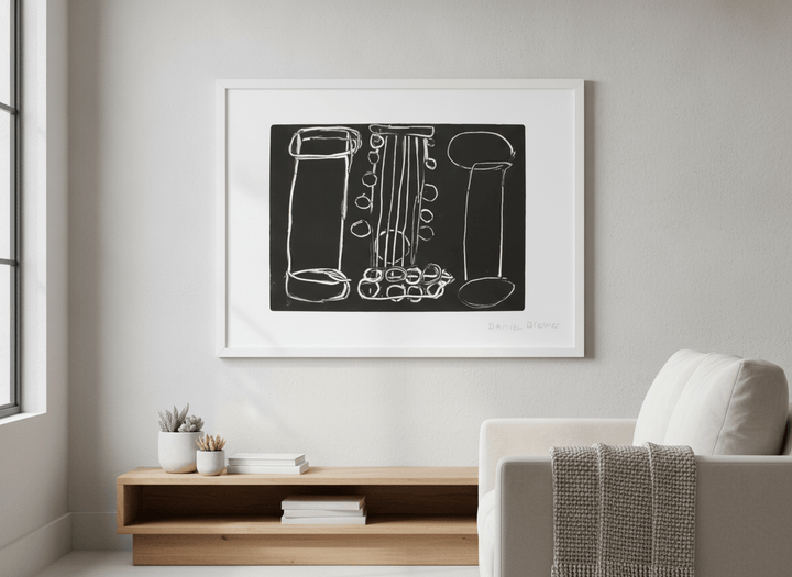 Modern wall art styled above a sofa in a neutral living room