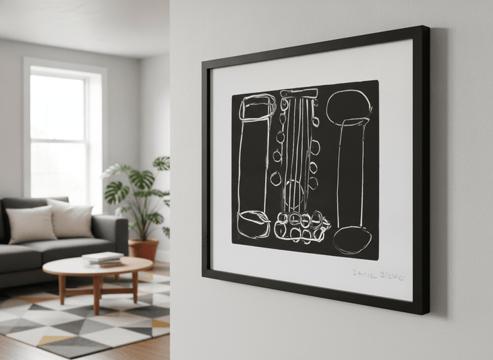 Modern wall art styled above a sofa in a neutral living room