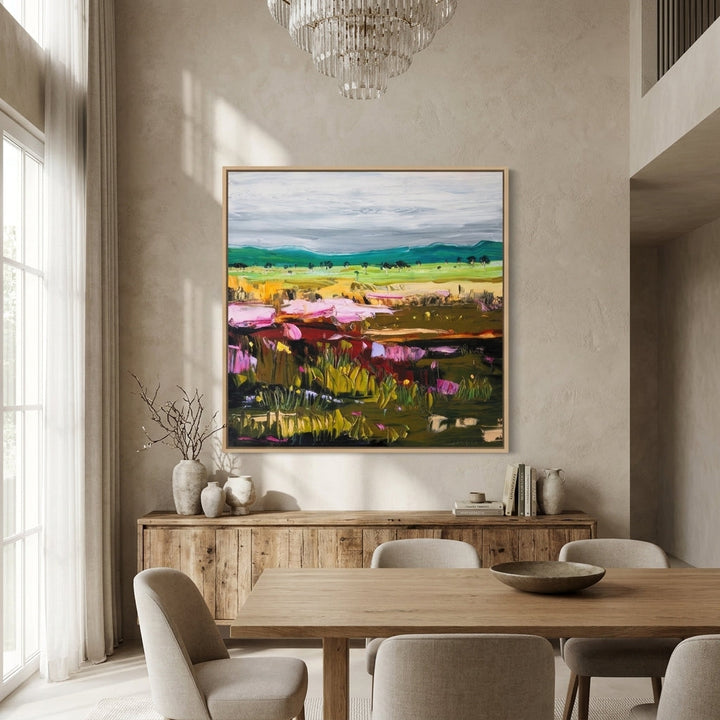 Oversized statement canvas wall art with a natural timber surround styled in a contemporary dining room