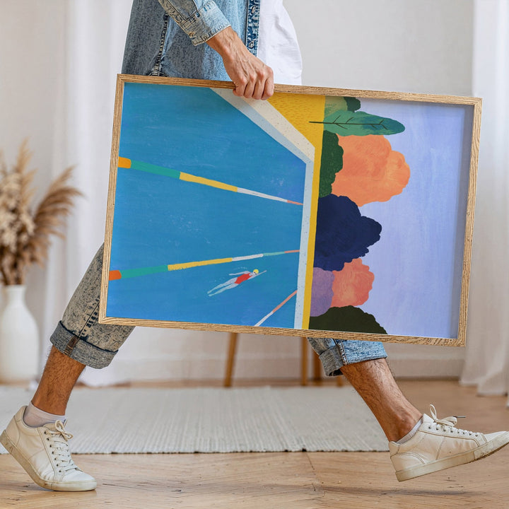 Person holding abstract art piece in a room with a neutral decor.