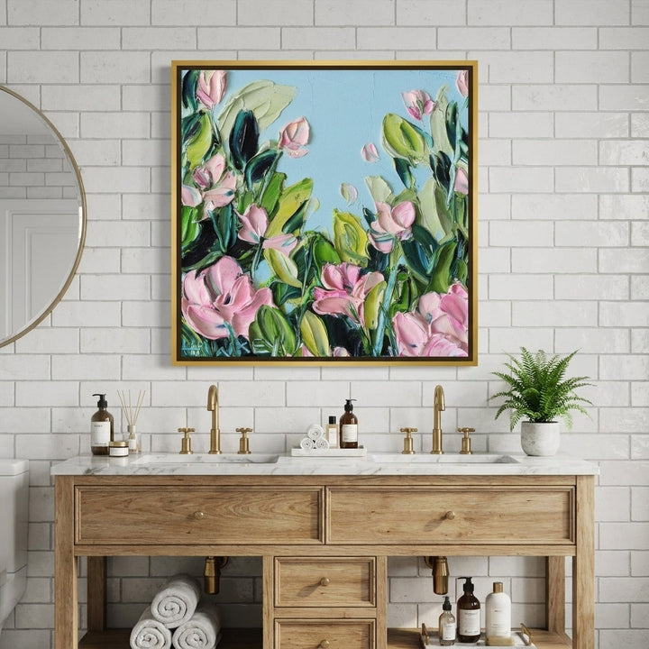 Canvas wall art with a gold leaf surround styled in a clean minimalist bathroom