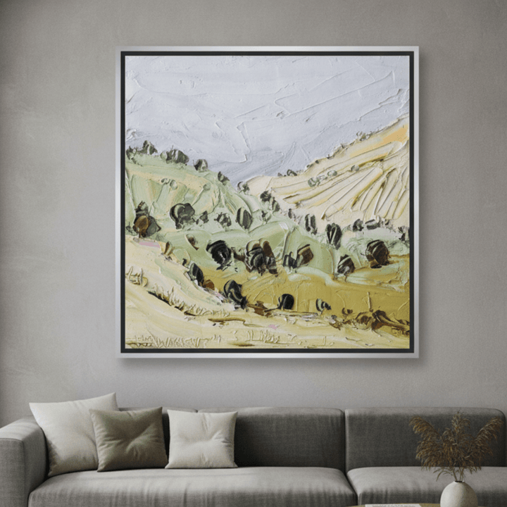 Oversized statement canvas wall art with a silver leaf surround styled in a neutral living room