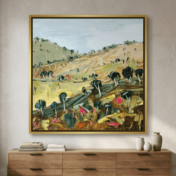 Oversized statement canvas wall art with a gold leaf surround styled in a luxe interior