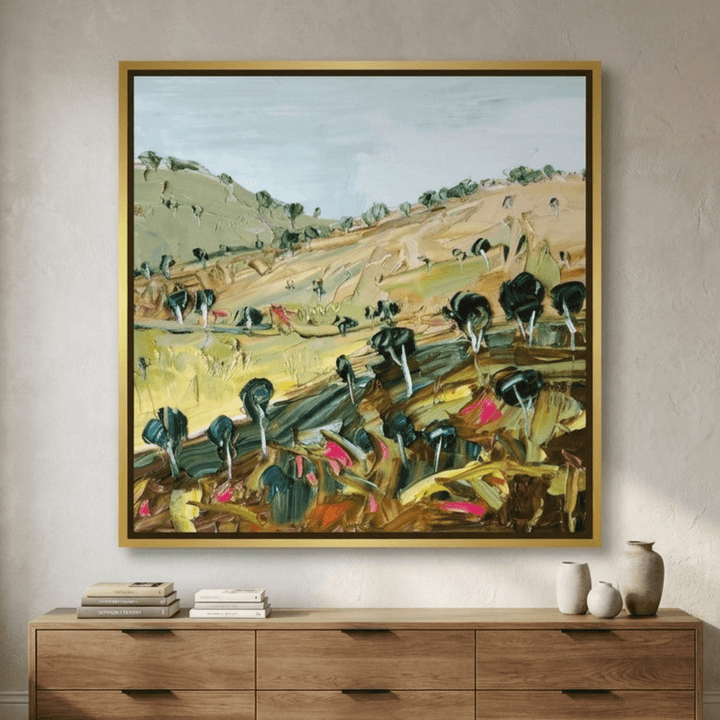 Oversized statement canvas wall art with a gold leaf surround styled in a luxe interior