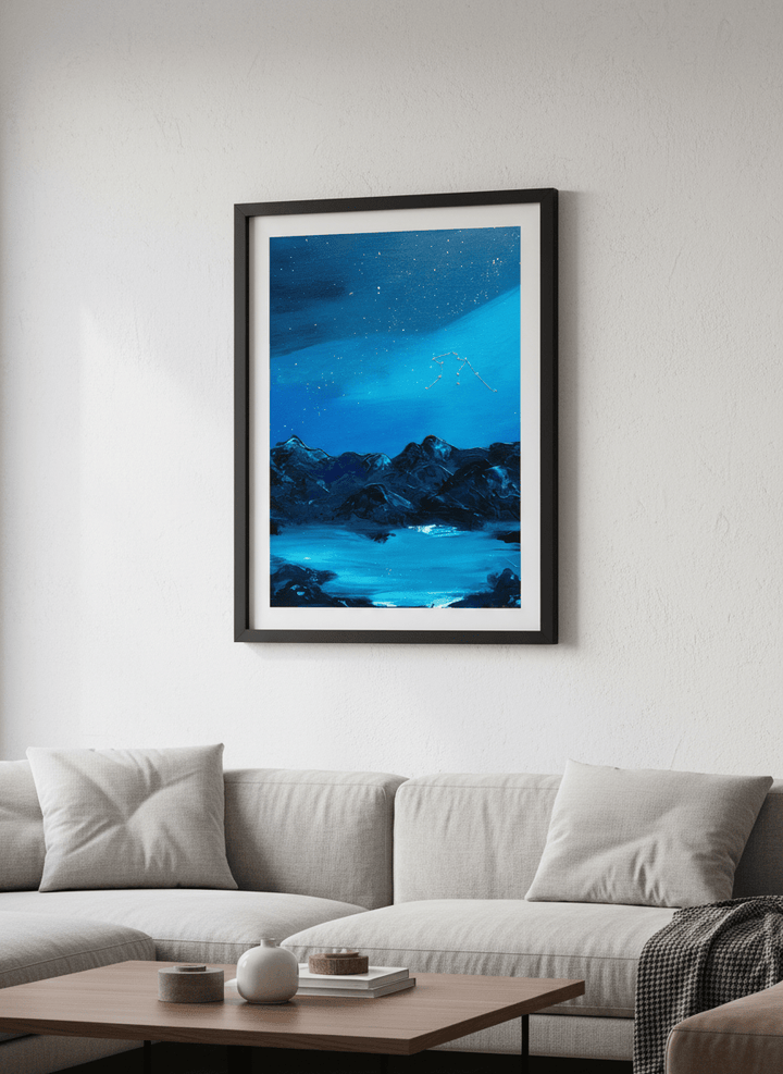 Modern wall art styled above a sofa in a neutral living room