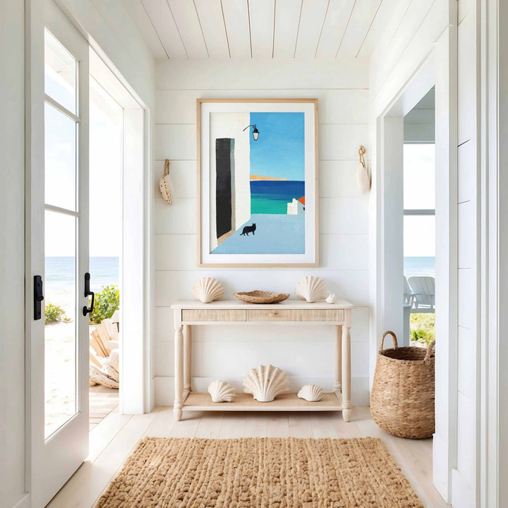 Nautical-themed interior with a console table, seashells, and a large window.