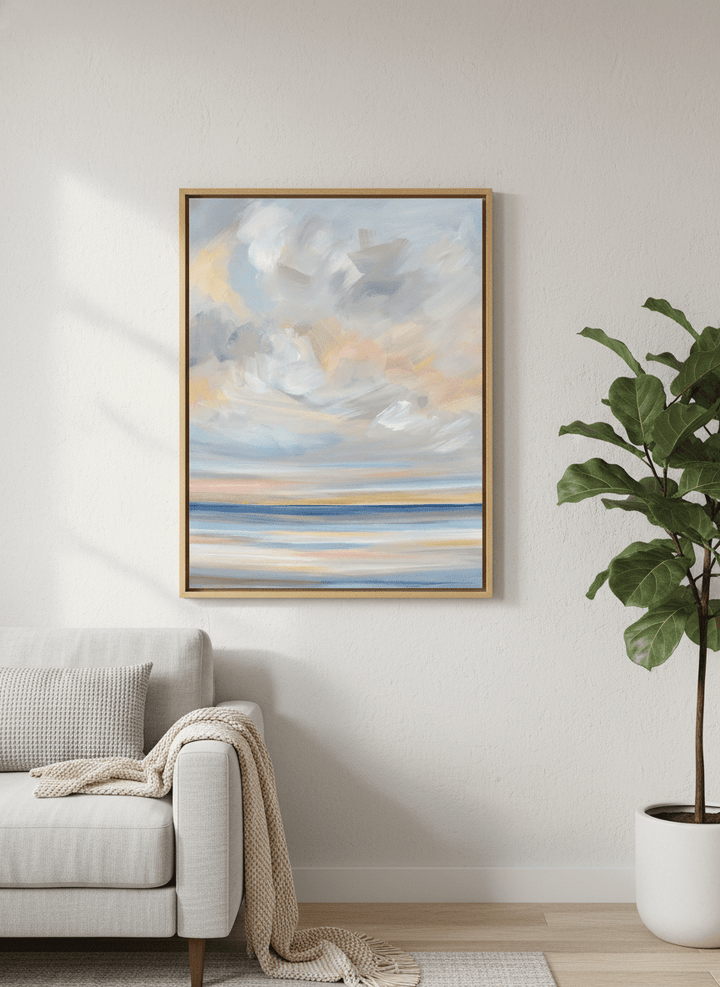 Modern wall art styled above a sofa in a neutral living room