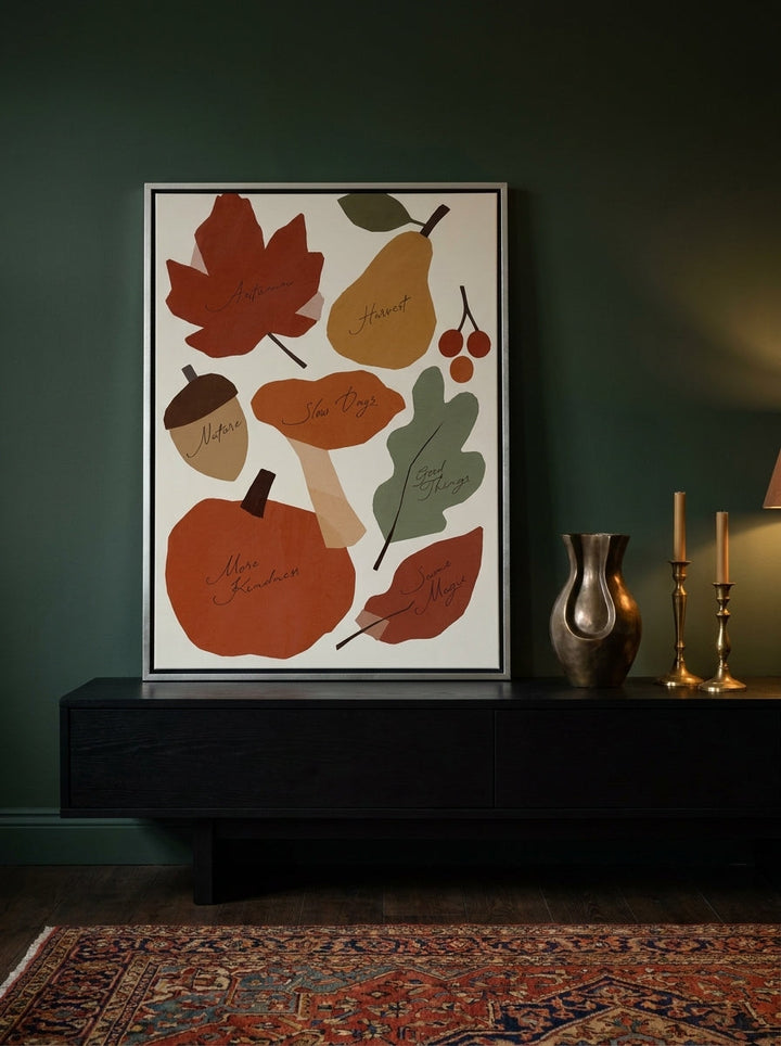 Canvas wall art with a silver leaf surround standing on a console in a moody dining room