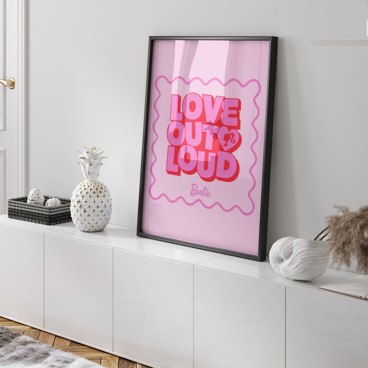 artwork with 'Love Out Loud' text on a white wall