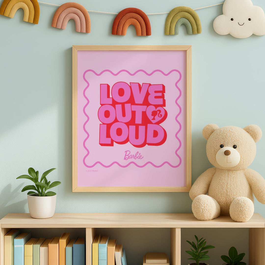 'Love Out Loud' Barbie poster on a shelf with a teddy bear and plants against a light blue wall.