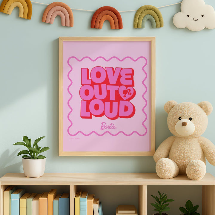 'Love Out Loud' Barbie poster on a shelf with a teddy bear and plants against a light blue wall.