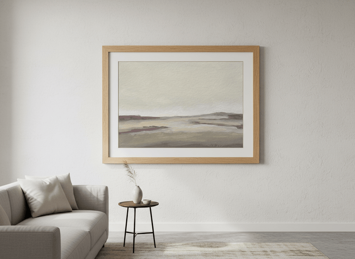 Modern wall art styled above a sofa in a neutral living room