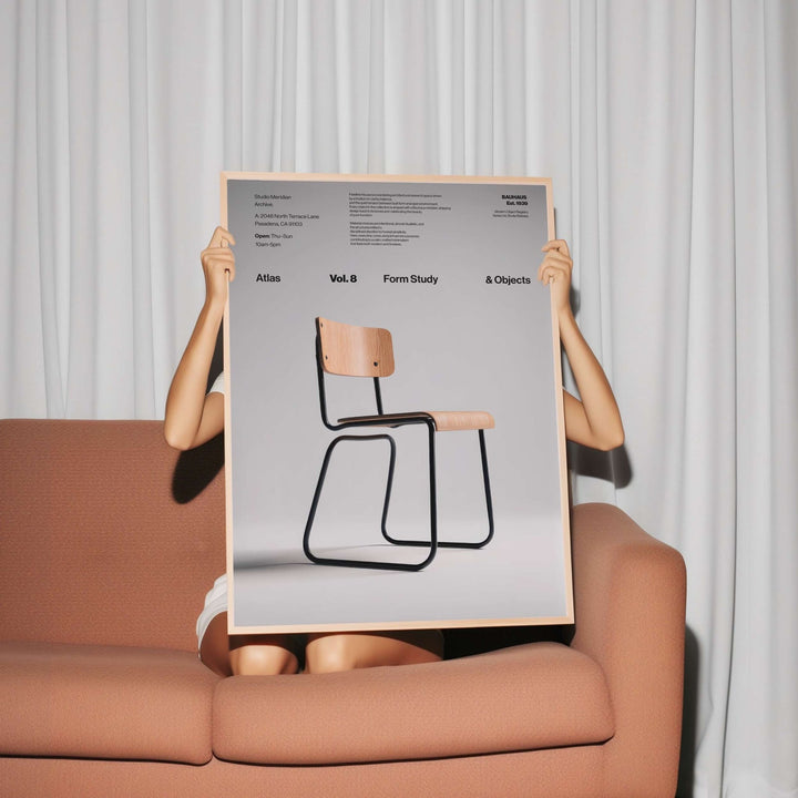 Person holding a poster of a chair design against a neutral background