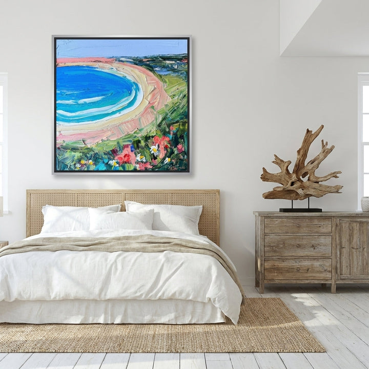 Oversized statement canvas wall art with a silver leaf surround styled on the wall in a coastal bedroom