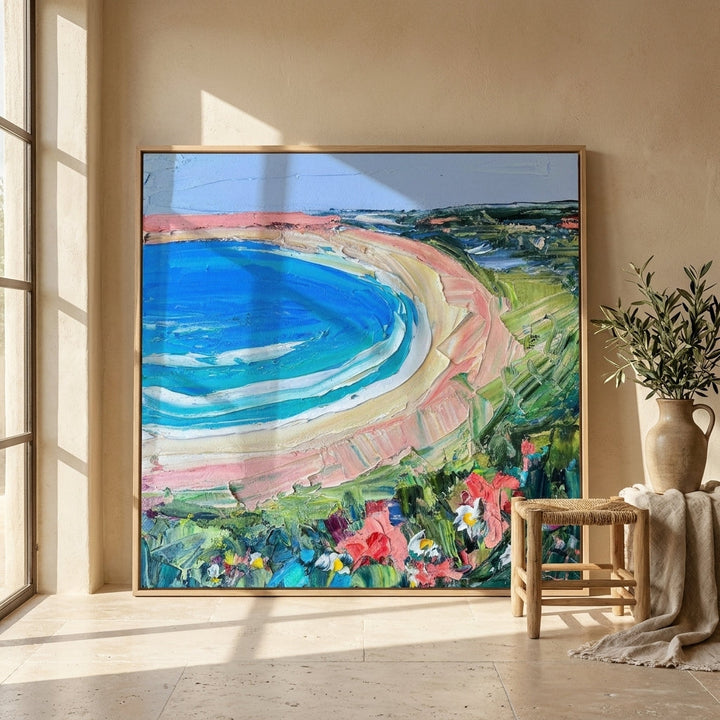 Oversized statement canvas wall art with a natural timber surround leaning against the wall in a Mediterranean living room