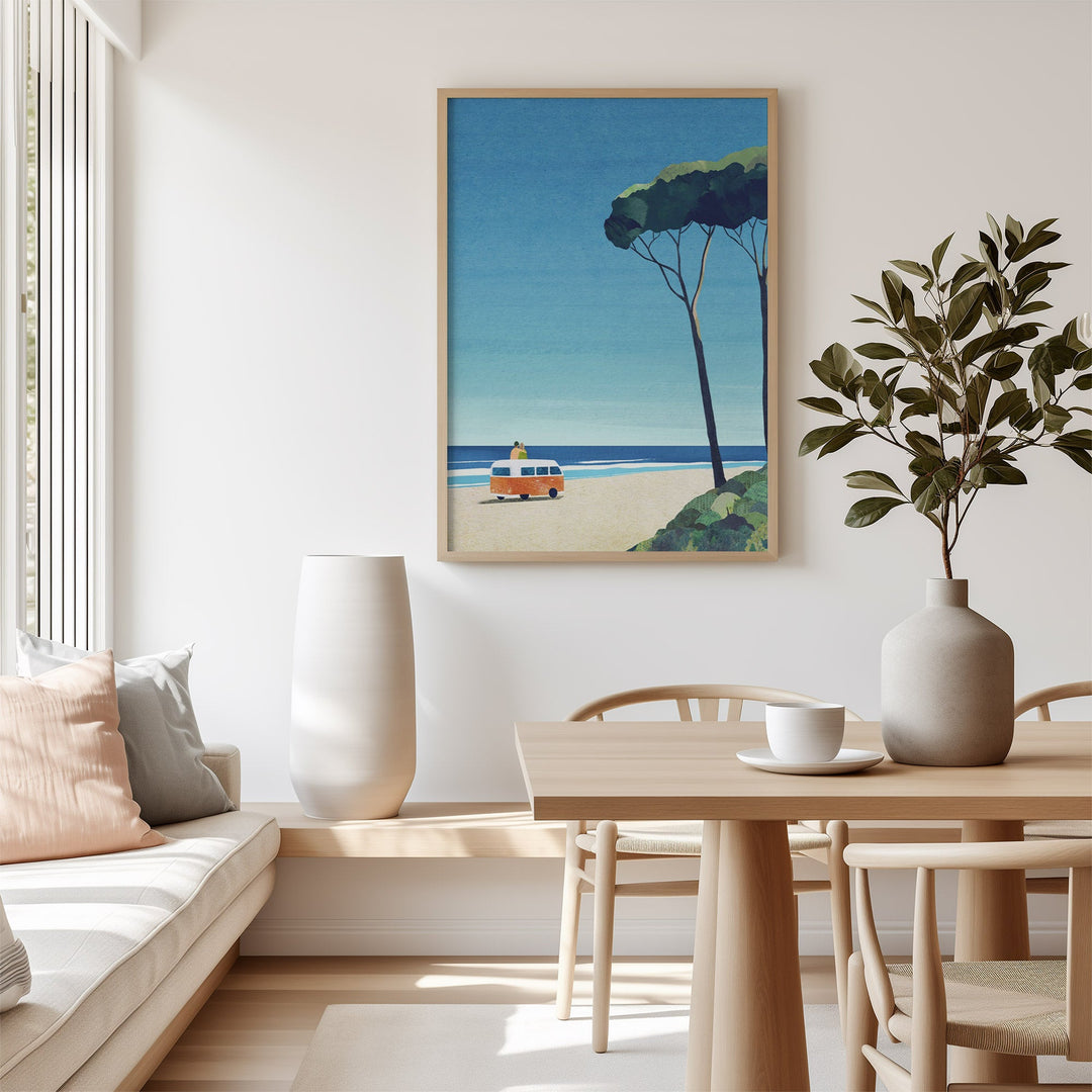 Artwork of a beach scene in a modern living room with a table and chairs.