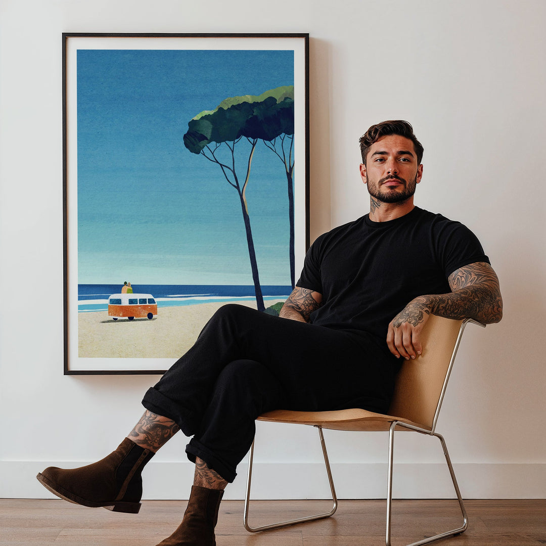 Man sitting on a chair in a room with an artwork of a beach scene.