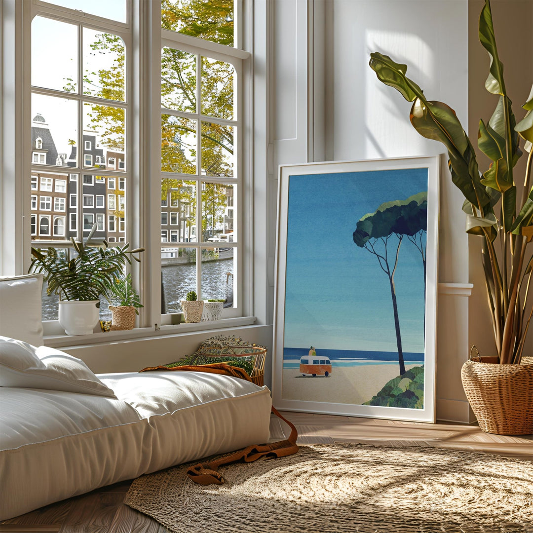 Cozy room with a large window, indoor plants, and artwork of a beach scene.