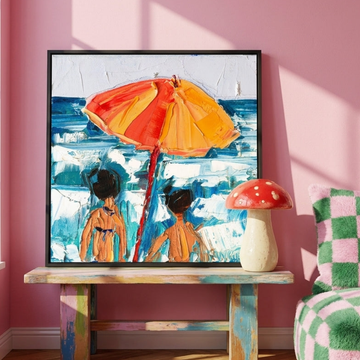 Canvas wall art with a black surround standing on a side table in a colourful eclectic bedroom