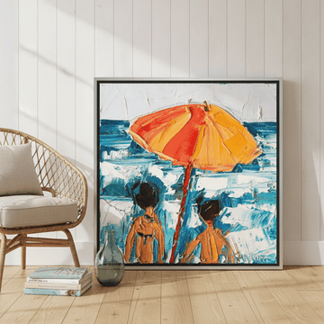 Canvas wall art with a silver leaf surround leaning against the wall in a coastal living room