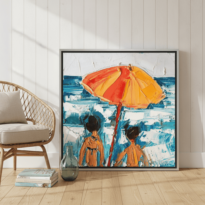 Canvas wall art with a silver leaf surround leaning against the wall in a coastal living room