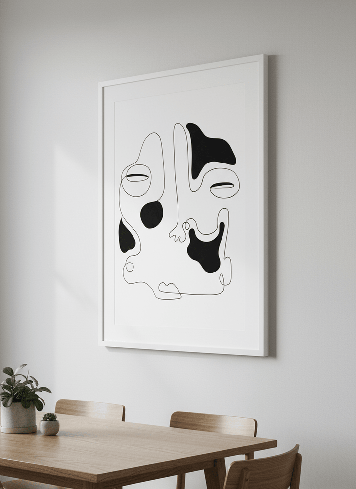 Wall art styled above a dining table in a contemporary home