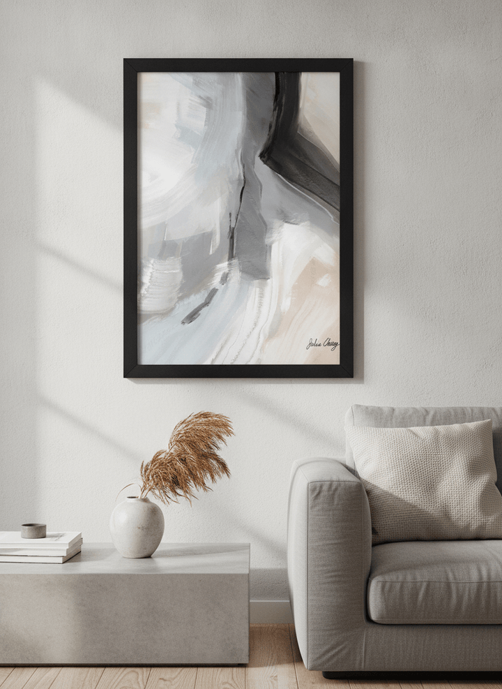 Modern wall art styled above a sofa in a neutral living room
