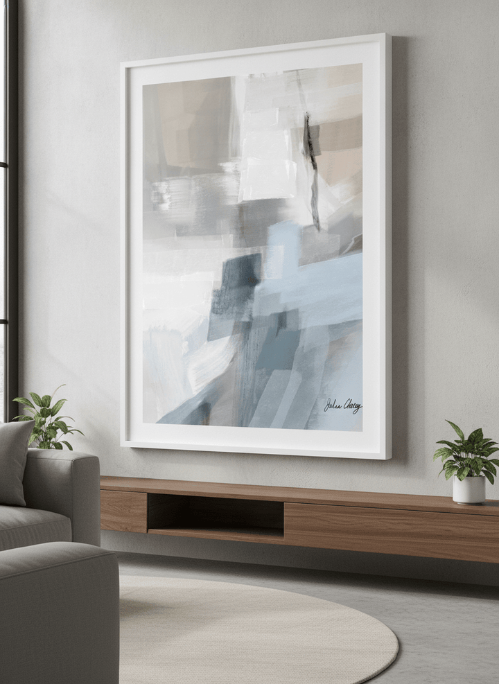 Modern wall art styled above a sofa in a neutral living room