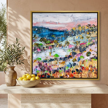 Canvas wall art with a gold leaf surround styled on the wall in a Mediterranean living room