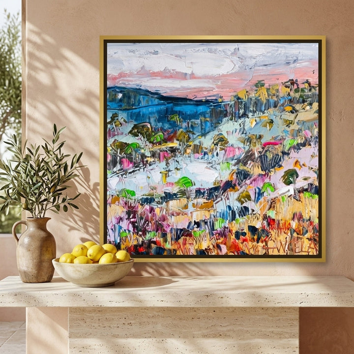 Canvas wall art with a gold leaf surround styled on the wall in a Mediterranean living room