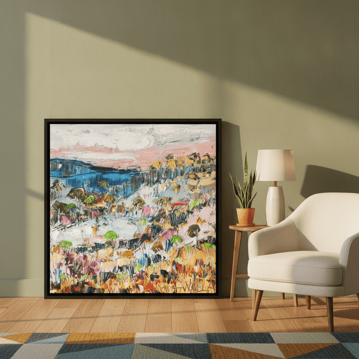 Canvas wall art with a black surround leaning against the wall in a mid-century home office