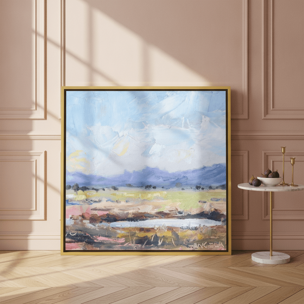 Canvas wall art with a gold leaf surround leaning against the wall in a Parisian living room