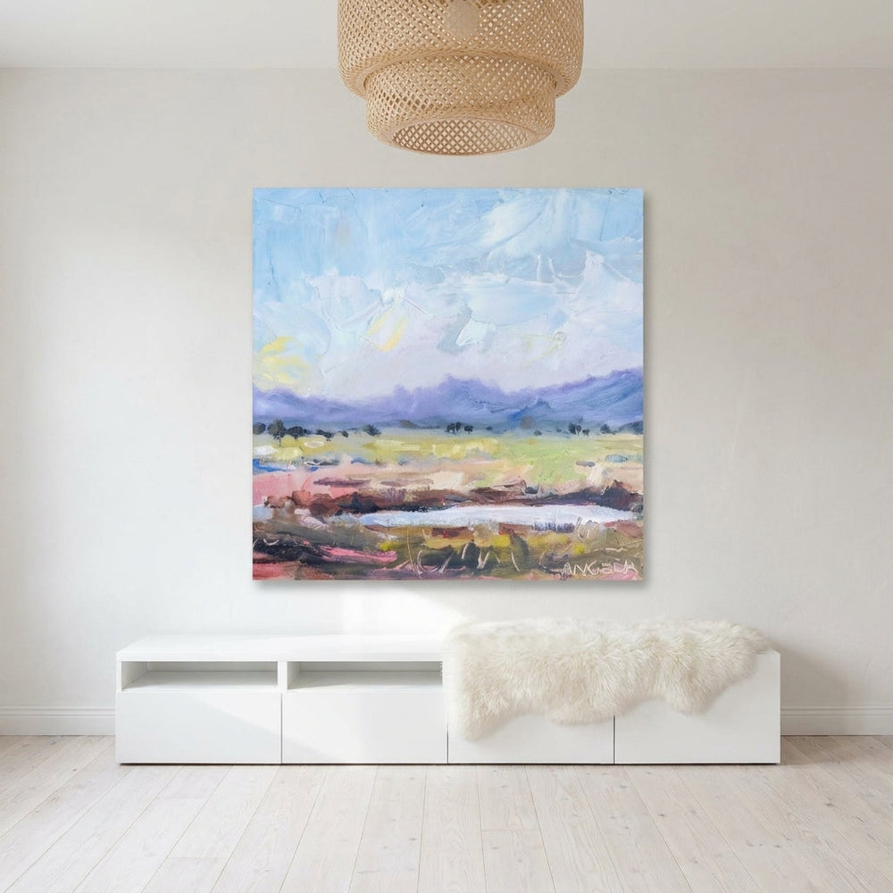 Stretched canvas wall art styled on the wall in a bright Scandinavian living room