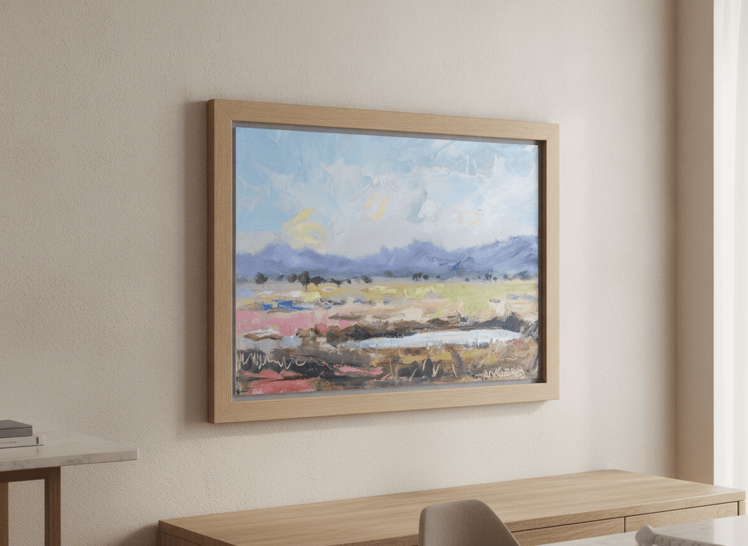Wall art styled above a dining table in a contemporary home