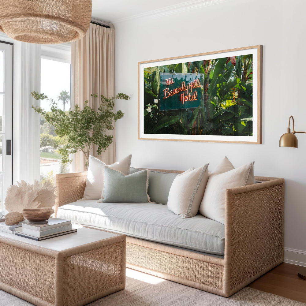 Living room with a couch, coffee table, and picture of the Beverly Hills Hotel.