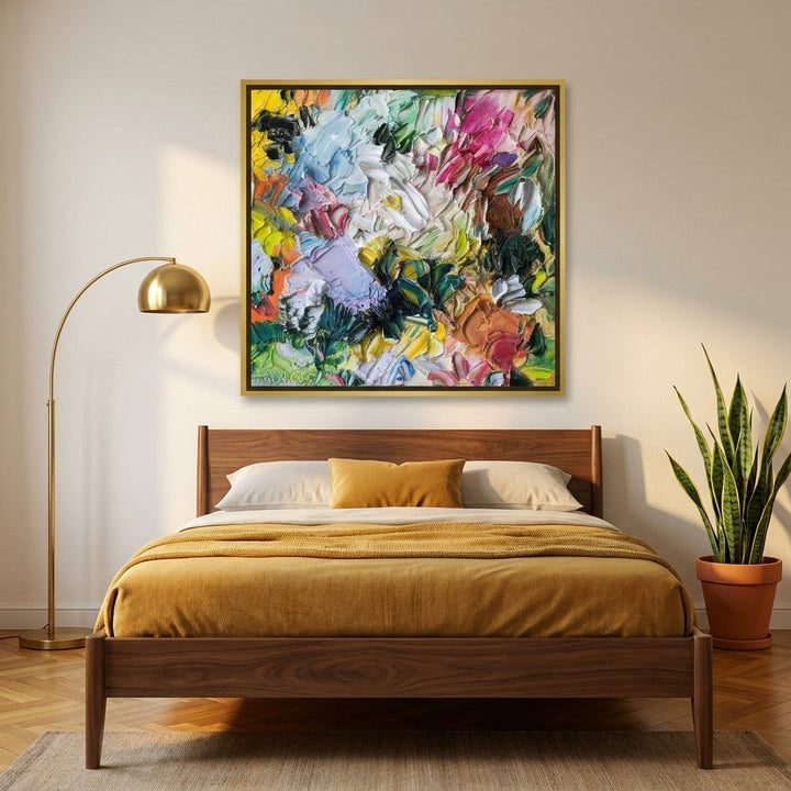 Canvas wall art with a gold leaf surround styled on the wall in a mid-century bedroom