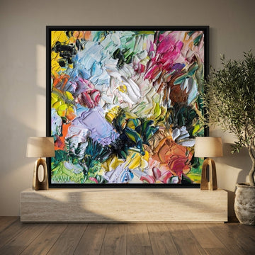 Canvas wall art with a black surround standing on a console in a luxe living room