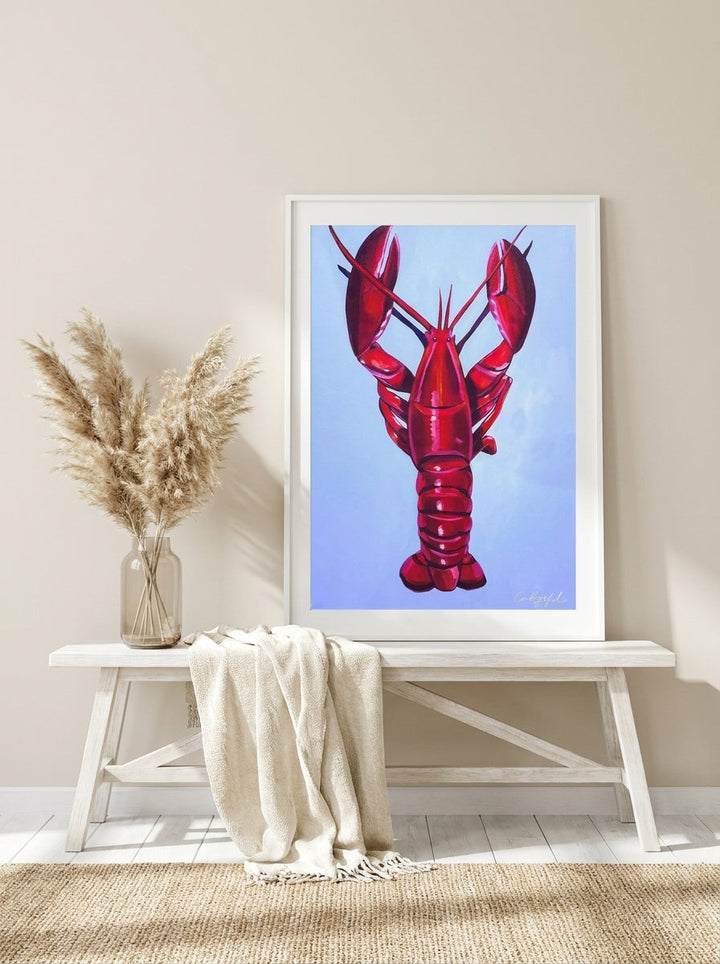 Modern wall art print standing on a console in a coastal dining room