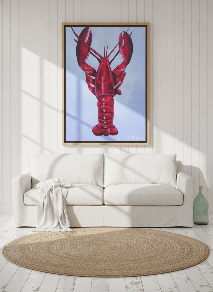Oversized statement canvas wall art with a natural timber surround styled on the wall in a coastal living room