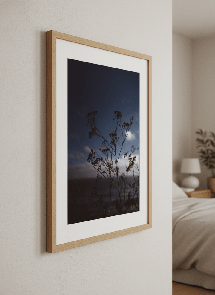 Minimalist artwork displayed in a calm, light-filled bedroom interior