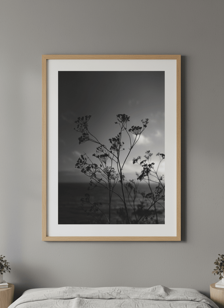 Minimalist artwork displayed in a calm, light-filled bedroom interior