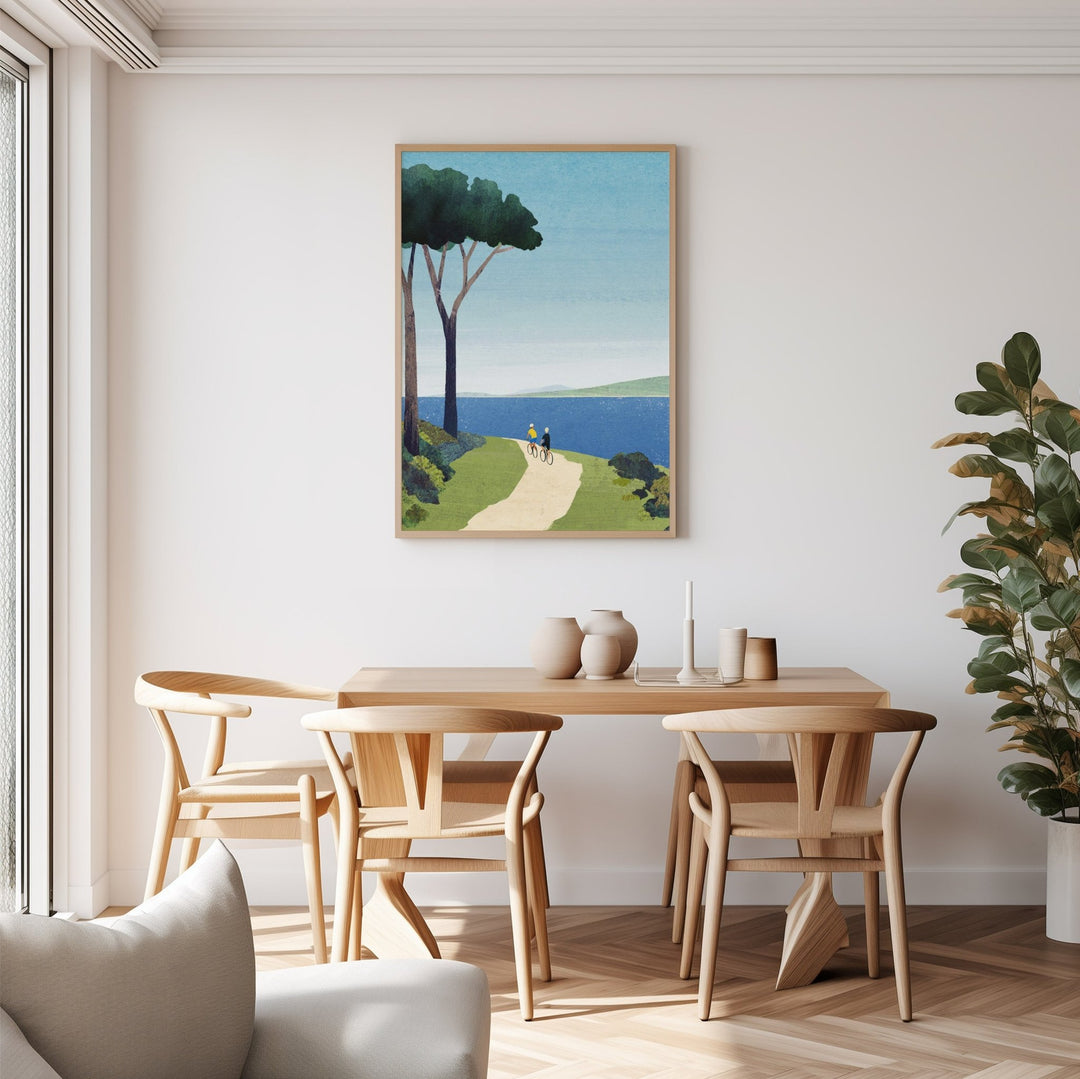 Dining room with wooden table and chairs, artwork on the wall, and a plant.