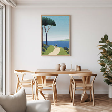 Dining room with wooden table and chairs, artwork on the wall, and a plant.
