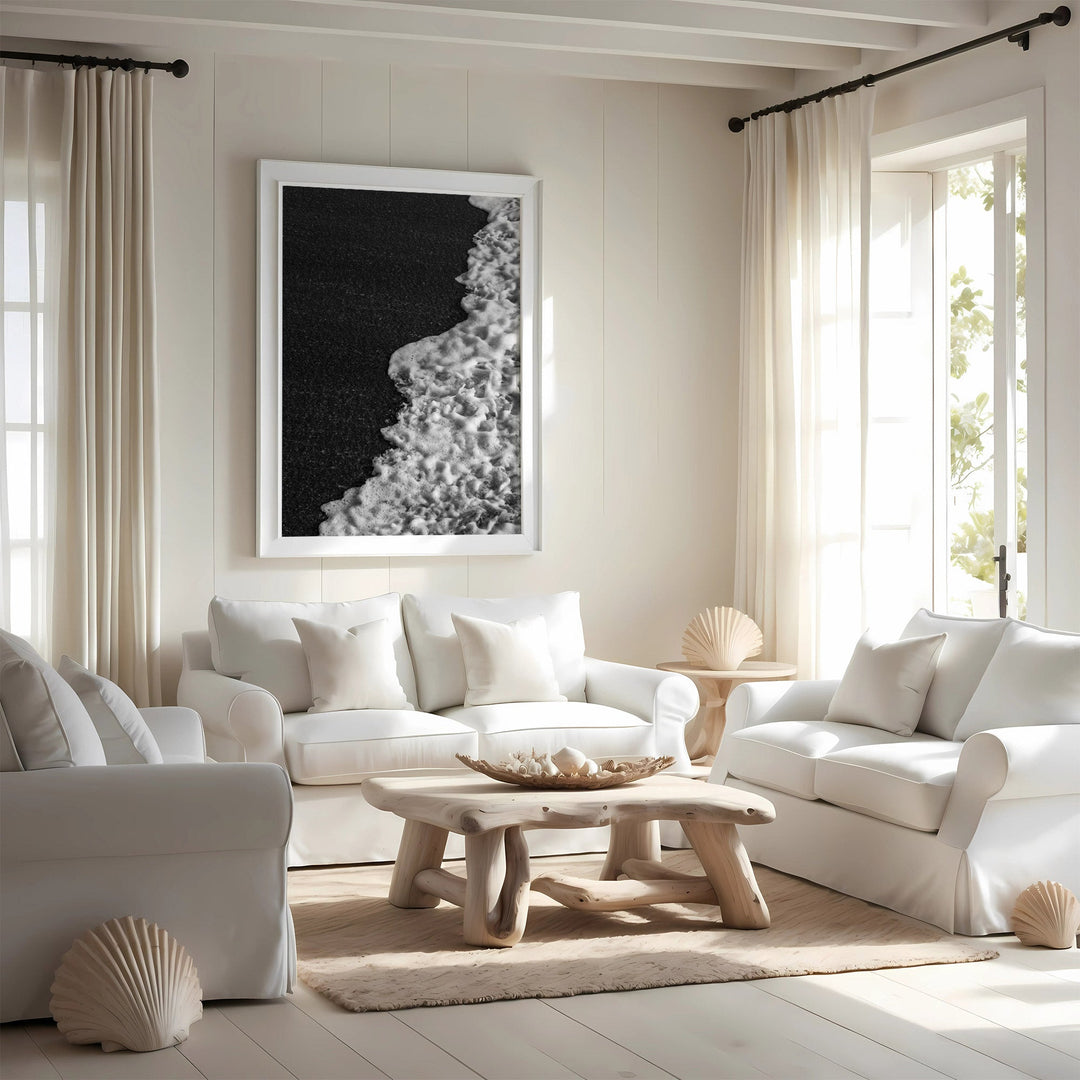 Modern living room with white furniture, a wooden coffee table, and decorative elements.