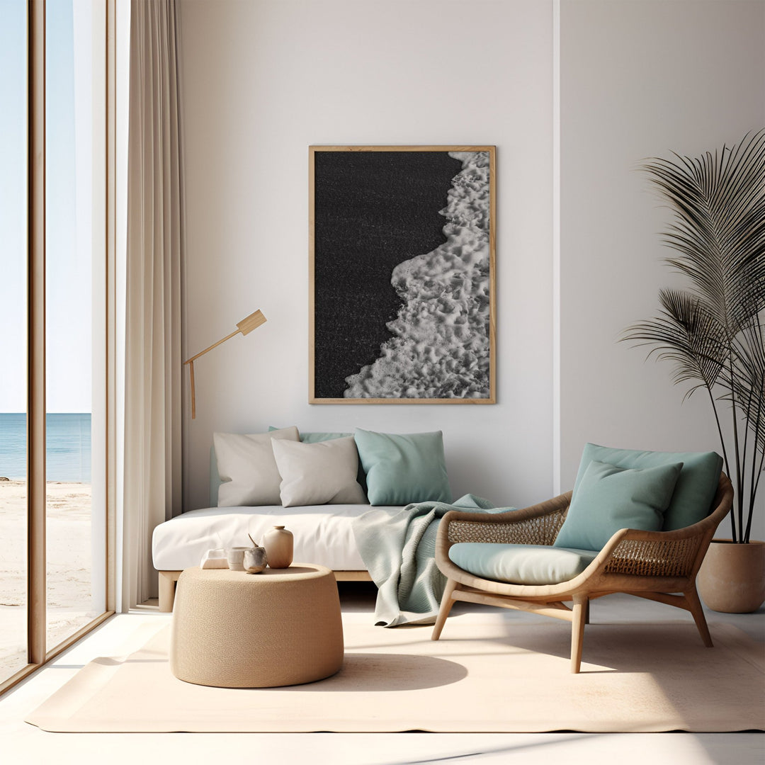 Modern living room with a beach view, featuring a sofa, armchair, and decorative elements.