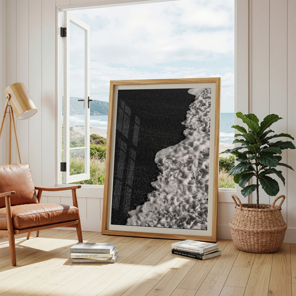 Black and white artwork in a modern living room with a view of the sea.