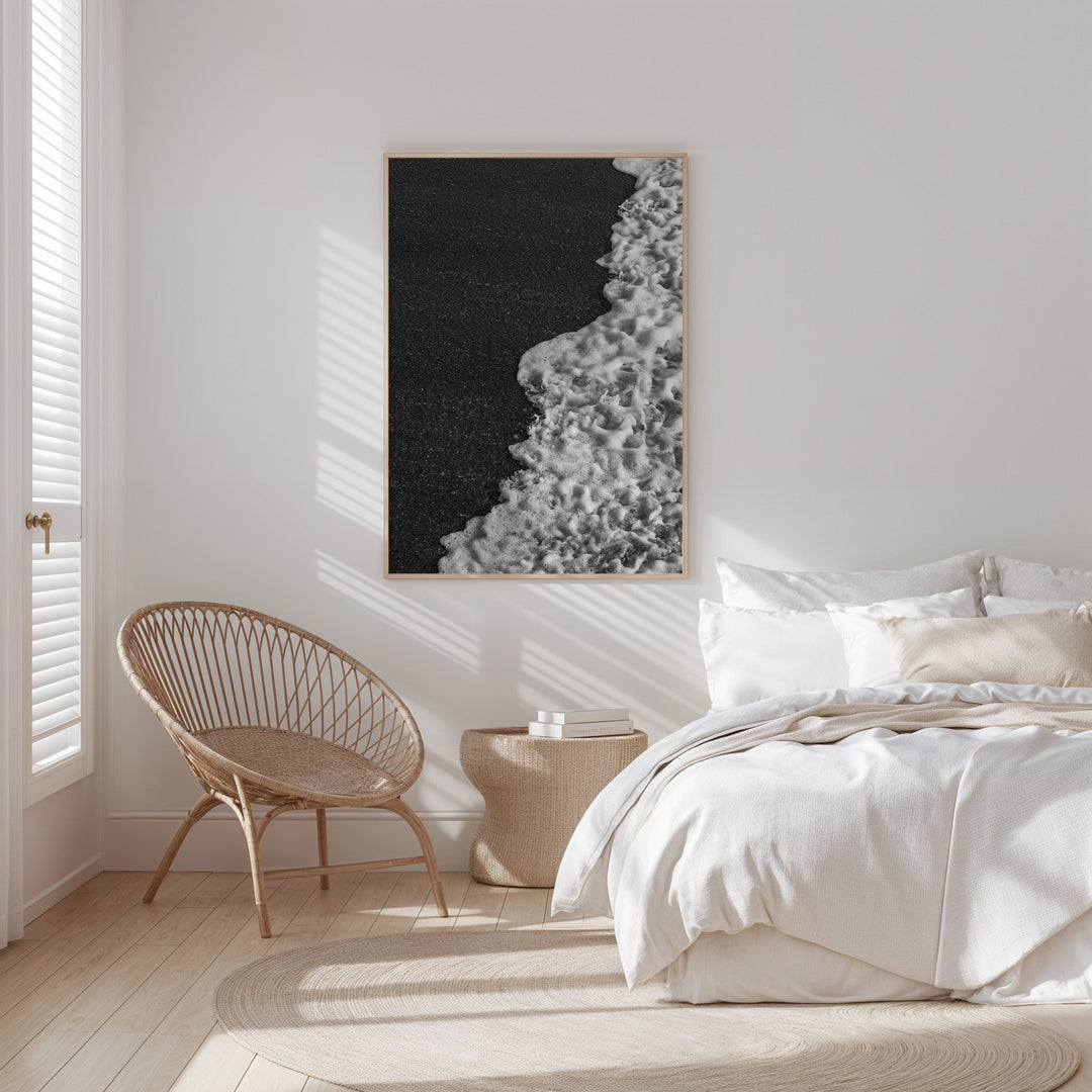 Modern bedroom with a bed, chair, and  artwork on the wall.