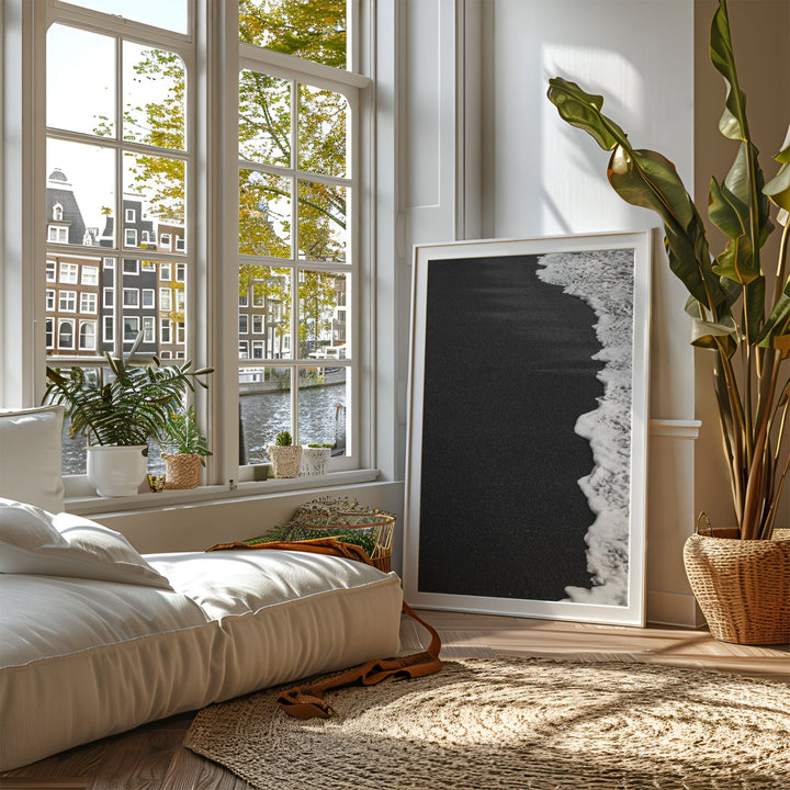 Living room with a large window, sofa, and artwork.