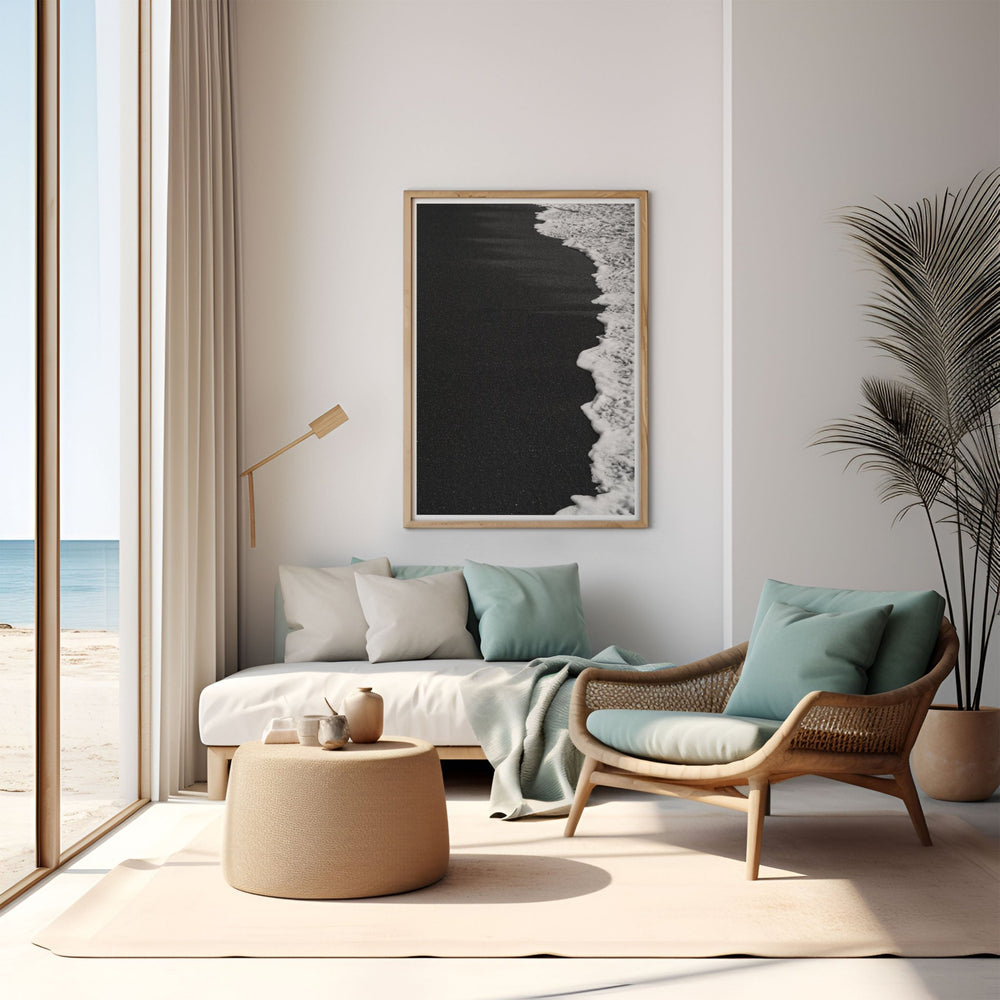 Modern living room with a beach-themed wall art piece, sofa, and armchair.
