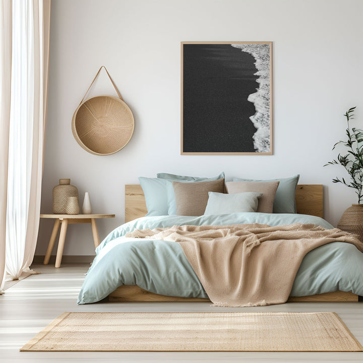 Modern bedroom with a bed, side table, and wall art.
